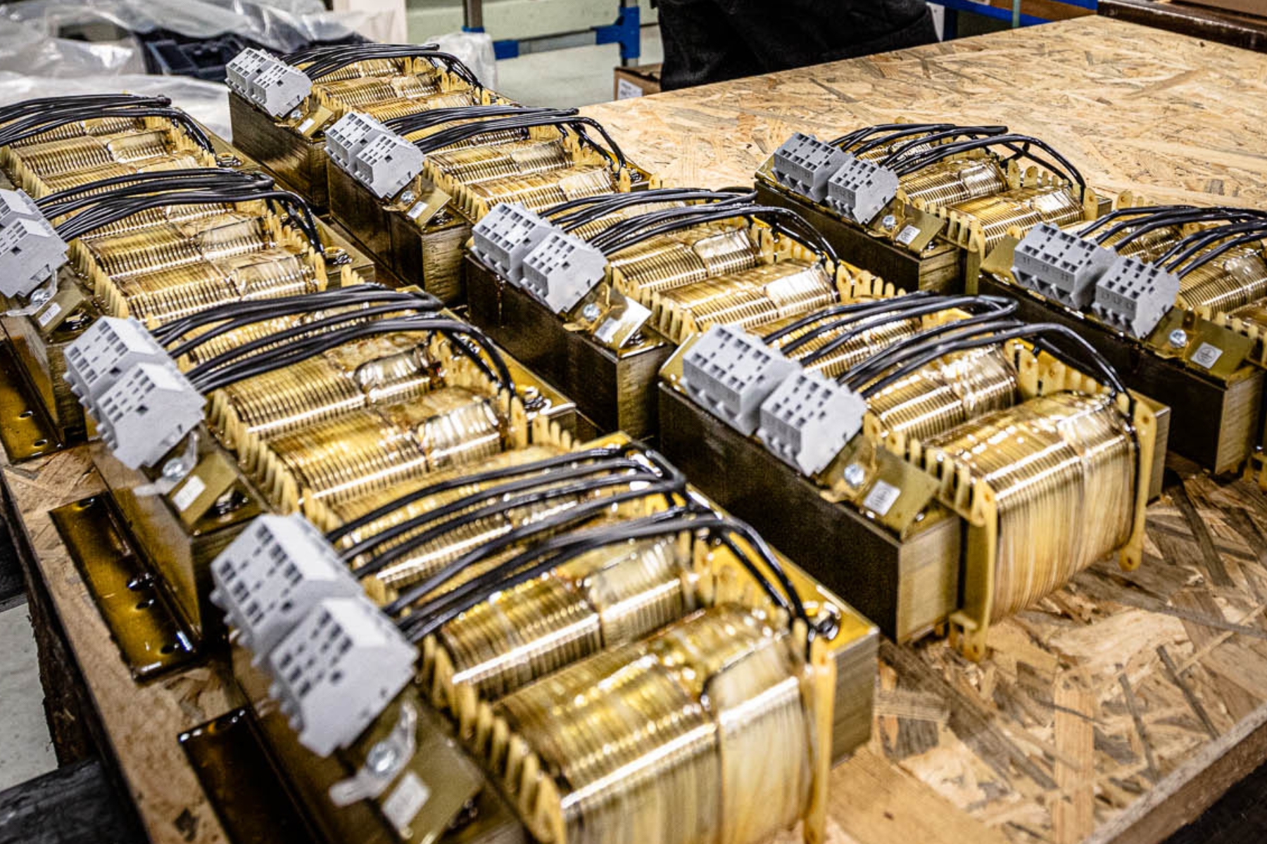 Picture of several Three-phase transformers on a table.