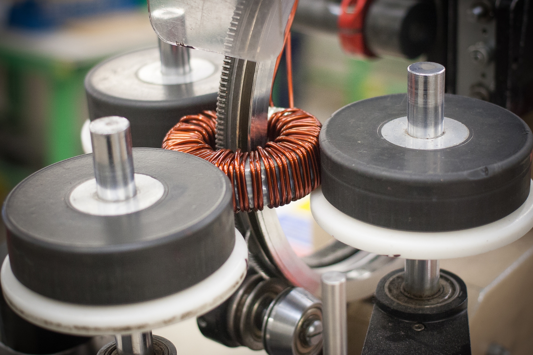 Picture of a torodial transformer being made.