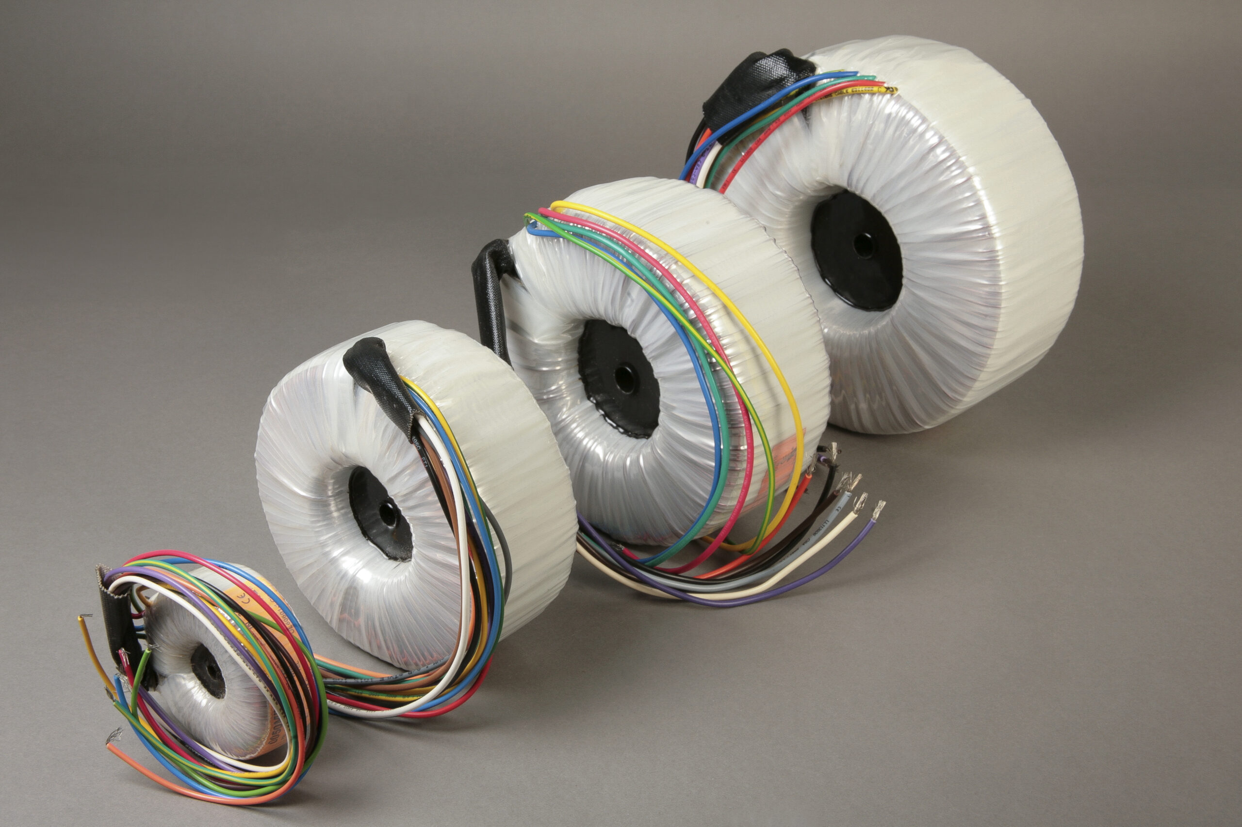 Picture of four medical grade transformers standing in order of size.